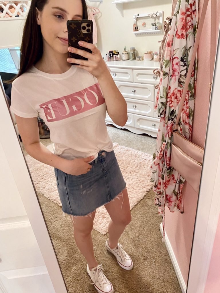 thredup review, levi's distressed and frayed denim mini skirt with silver hardware found at the world's largest online thrift store, thredup, styled with a pink and white metalic vogue lettered tee shirt and white low top converse sneakers with a pearl hair clip
