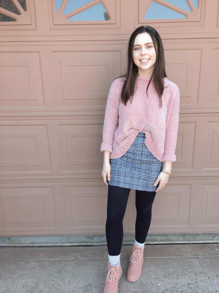 plaid skirt for winter outfit, pink chenille sweater with gray plaid skirt, black leggings, and pink combat boots. very affordable and cheap outfit.