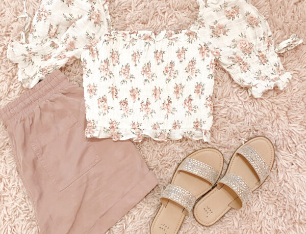 shabby chic outfit with white and pink vintage floral top, pink tie waist shorts, and embellished sandals